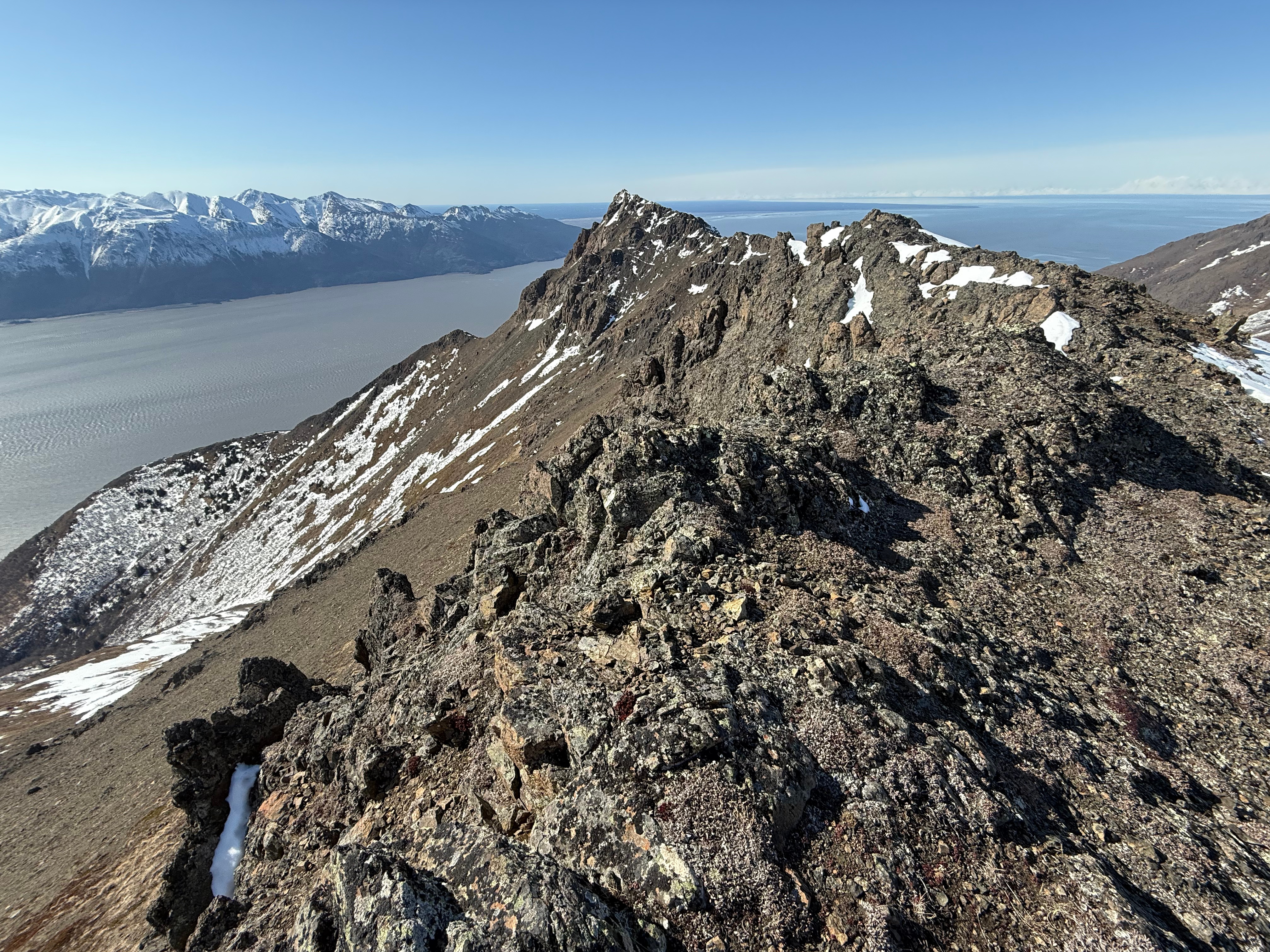 Facing back along the rocky ridge to the summit of Rainbow Peak