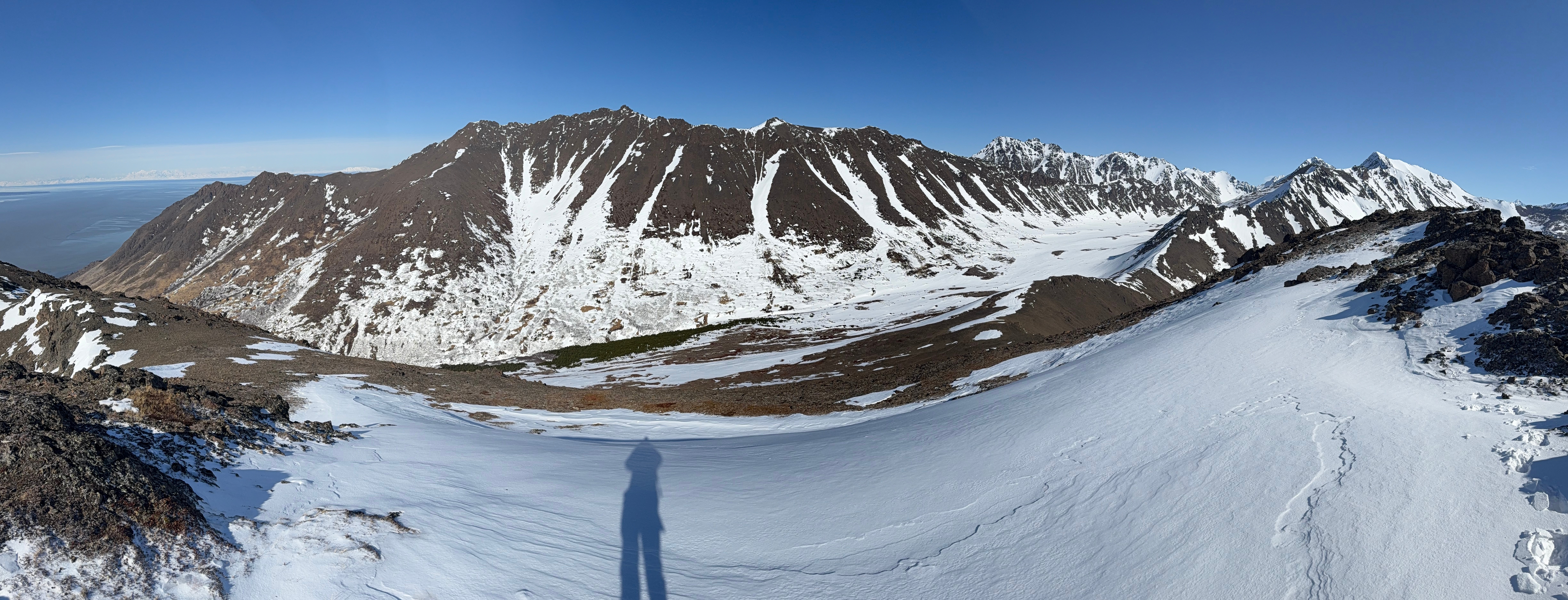 A panorama of the McHugh Ridgeline. The author's shadow is projected onto the snowy slope.