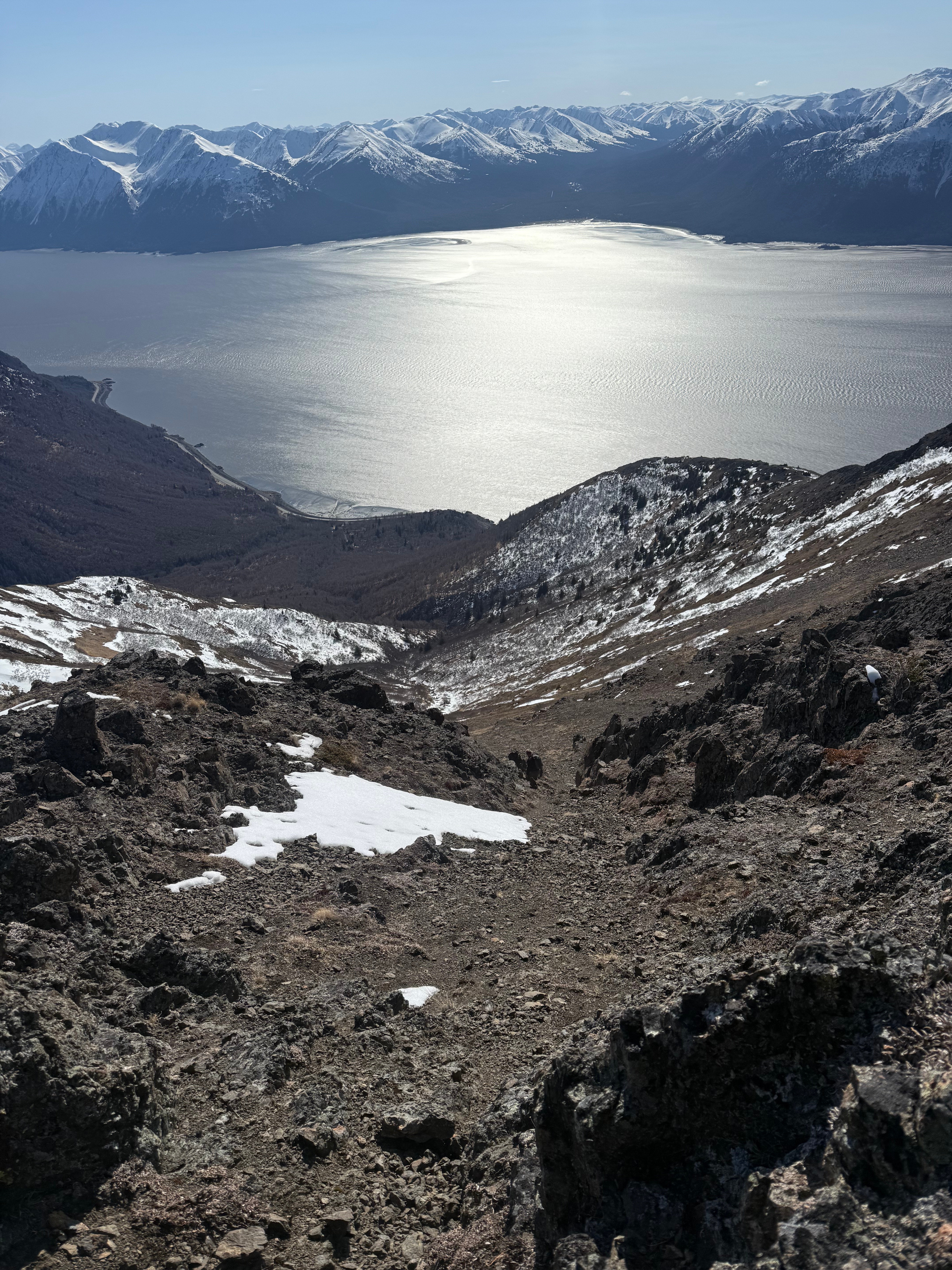 Facing down a steep scree slope towards the ocean