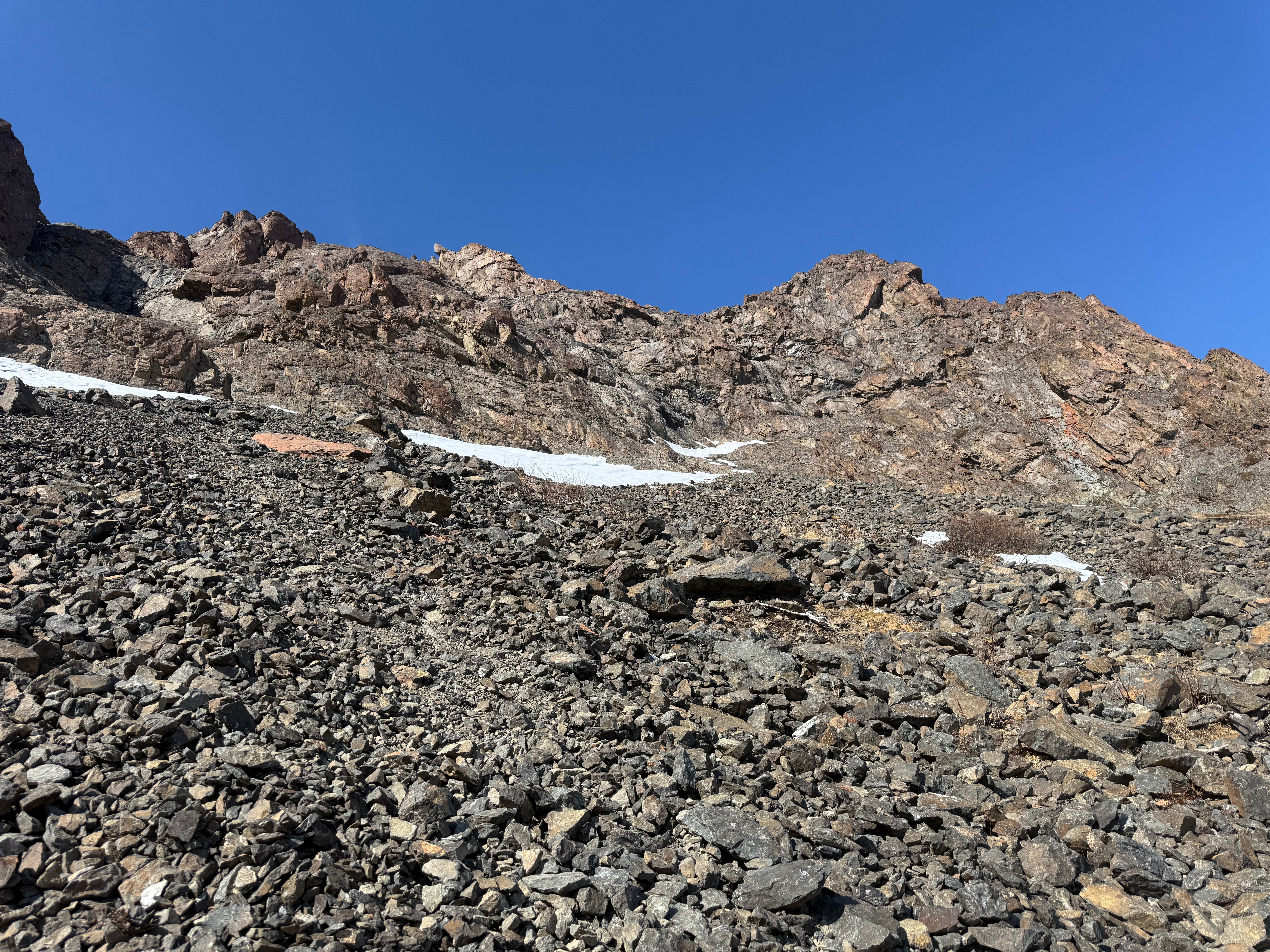 Facing back up the rocky slope to the summit ridge