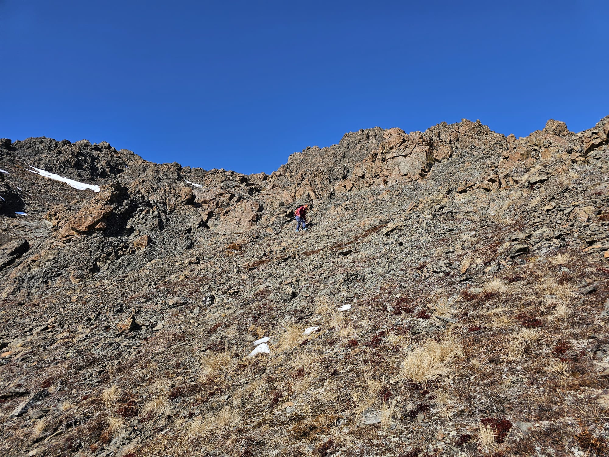 The author is high up on the ridge, slowly picking her way down through the rocks