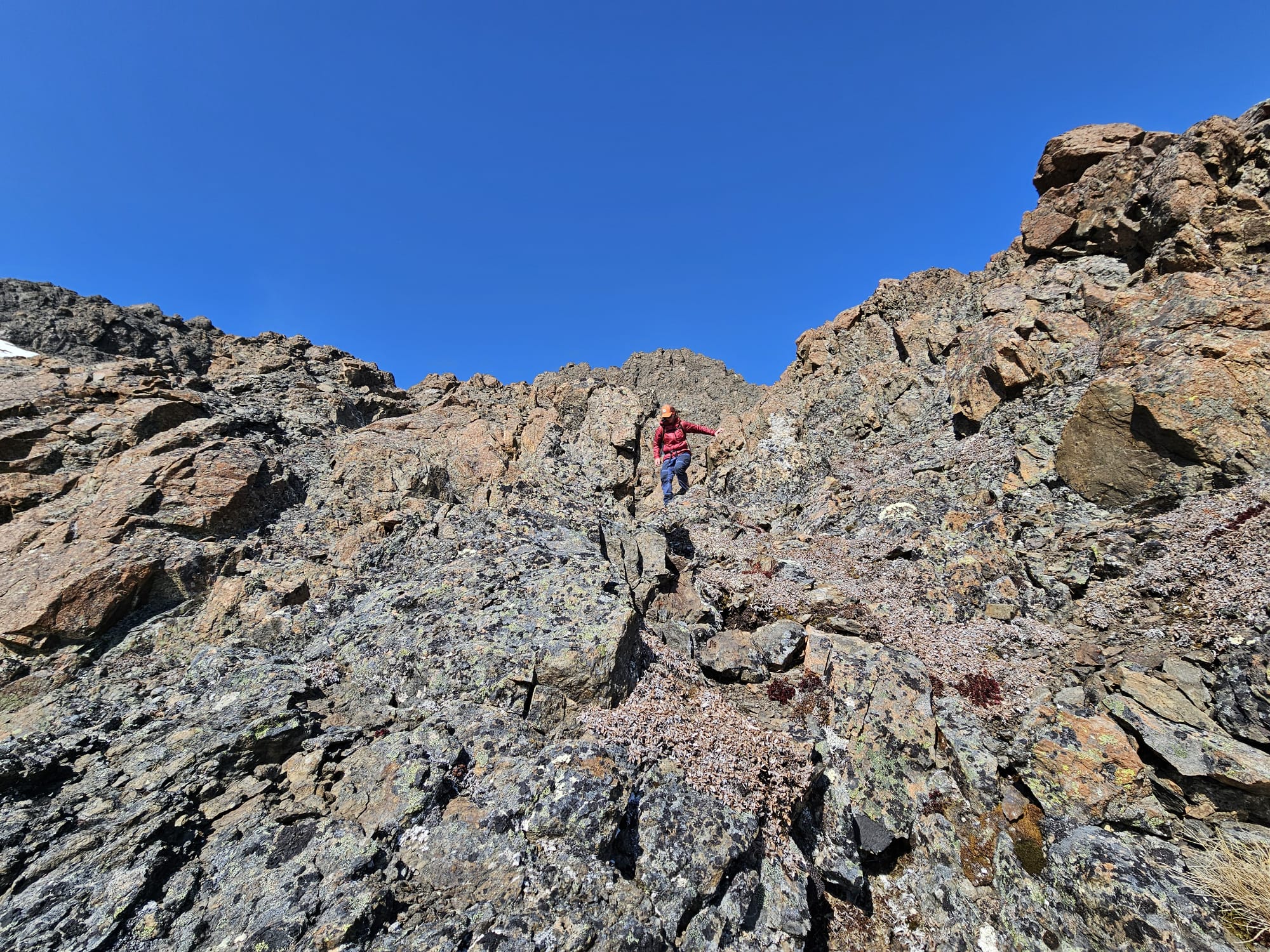 The author is descending through steep, rocky terrain