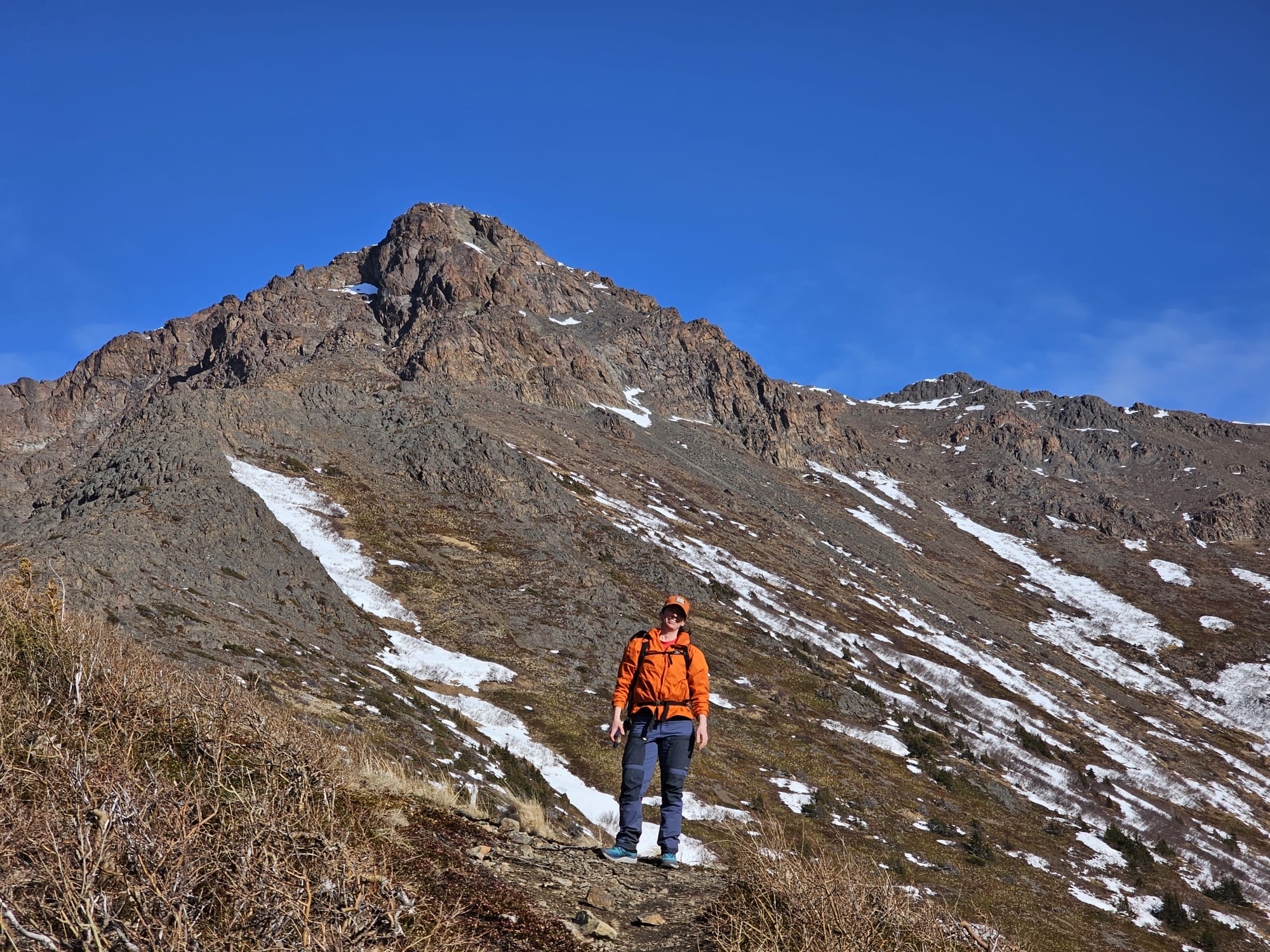 The author standing in front of a mountain peak